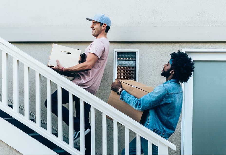 roommates moving boxes together